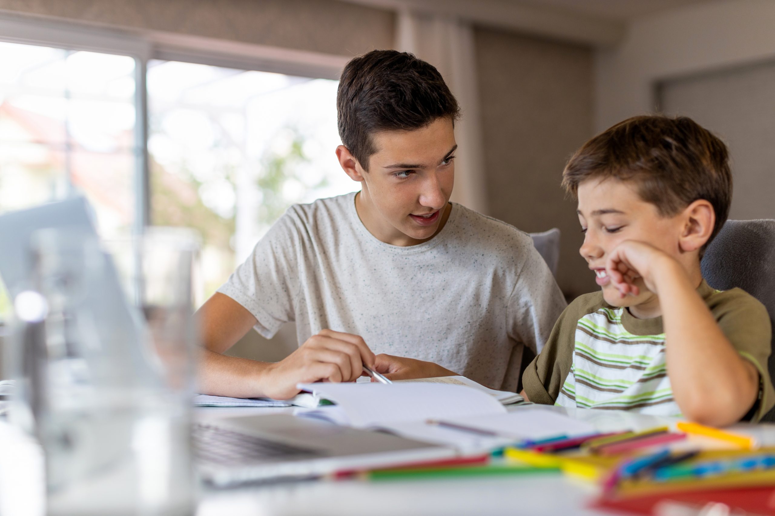 They doing homework at present. Help boy. A boy helping at Home. Helping at Home. Helping his student.